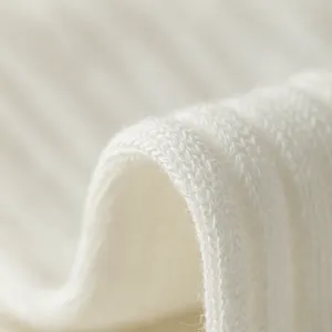 White ribbed knit cotton socks fabric main view, soft textured knitwear material close-up.