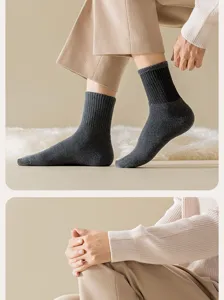Detail view of men winter thickened solid color mid tube socks with comfortable ribbed cuffs.