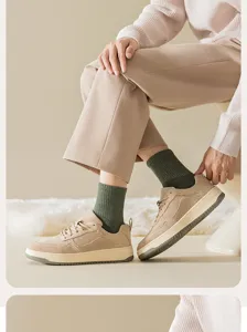 Detailed view of men's green loop socks paired with casual khaki shoes and pants, cozy style.