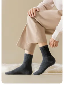 Close-up detail shot of men's thermal winter cotton terry socks in solid dark grey color.