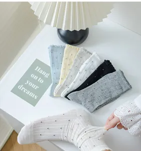 Detail view of women's breathable cotton socks with cute polka dots and delicate ruffles.