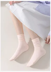 Detail view of comfortable women pink cotton slouch socks, soft daily wear apparel.