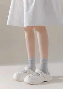 Detail view of women's breathable mid-tube grey cotton casual socks worn with shoes.