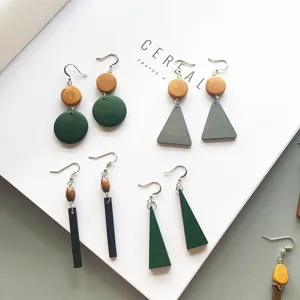 Detailed view of handmade geometric wooden drop earrings in various shapes and colors