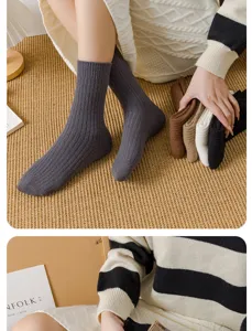 Detailed shot of thick ribbed wool knit mid-calf socks in various cozy winter colors.