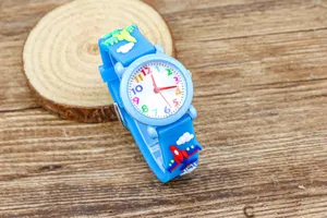 Close-up detail of children blue silicone quartz watch with colorful dial numbers and plane strap.