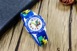 Close-up detail view of the cute children's cartoon excavator watch with blue strap.