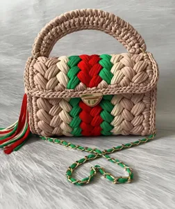 Handmade crochet shoulder bag with colorful stripe design, chain strap and tassel.
