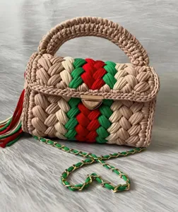Handmade chunky knit crochet handbag with vibrant red green and beige stripes and chain strap.