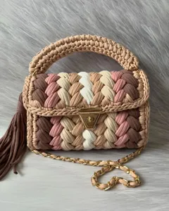 Handmade crochet shoulder bag with color-block design, chunky top handle and chic gold chain.