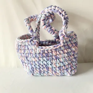 Handmade crochet shoulder bag with colorful fabric yarn, stylish knitted handbag details.
