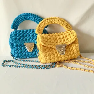 Handmade crochet women's shoulder bag with chic chain strap and secure metal lock closure.
