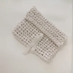 Handmade ribbon crochet tablet pouch detail showing delicate woven texture and cute bow tie.