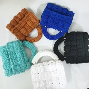Handmade crochet chunky knit mini square bag detail showcasing multiple vibrant color options.