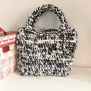 Handmade crochet handbag with black and white knit design, large capacity and stylish look.