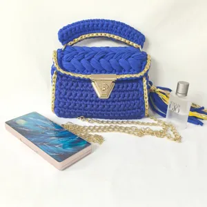Handmade blue crochet handbag with gold chain strap and metal lock closure for women.