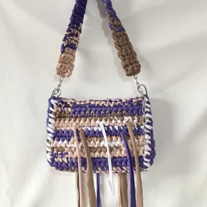 Handmade crochet fabric fringe small square bag detail showing woven texture and chain.