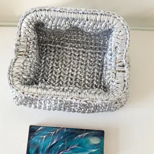 Silver woven crochet kiss-lock bag, stylish handmade cloth strip clutch and chic storage basket.