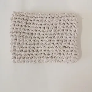 Handmade ribbon crochet tablet pouch detail, textured woven storage bag for everyday use.