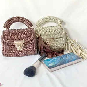 Handmade metallic crochet shoulder bag detail, stylish woven texture and elegant lock clasp.