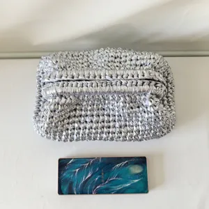 Silver crochet clutch bag for women, sparkling metallic woven underarm handbag for daily fashion.