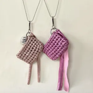 Handmade crochet mini earphone bag necklace detail shot featuring metallic chain and ribbon fringes.
