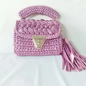 Handmade metallic crochet shoulder bag detail, stylish purple woven square purse with tassel accent.