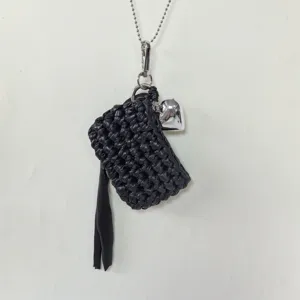 Handcrafted crochet mini earphone bag necklace with silver heart charm and tassel detail.