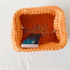 Handmade crochet t-shirt yarn clutch bag with metal chain strap and stylish frame lock.