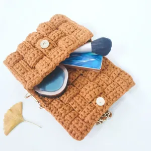 Handmade crochet crossbody bag for women stylish brown woven shoulder bag with chain strap.