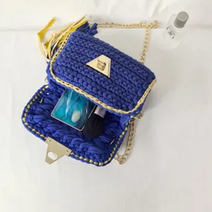 Handmade royal blue crochet crossbody bag with gold chain strap and chic tassel detail.
