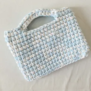 Handmade crochet handbag with blue and white color block design, stylish knit tote bag for women.