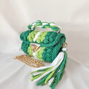 Handmade crochet woven handbag detail showing vibrant green color block and metal hardware.
