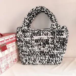Handmade black and white crochet tote bag with large capacity, stylish woven handbag for women.