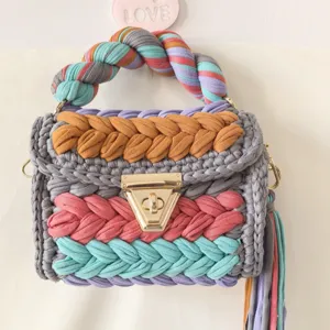 Handmade colorful crochet crossbody bag detail showing vibrant fabric yarn weave.