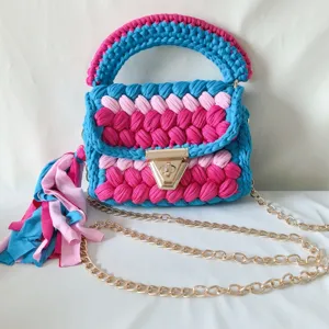 Handmade crochet shoulder bag with colorful t-shirt yarn, gold chain strap and chic tassel.