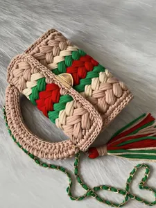 Handcrafted crochet crossbody bag with vibrant color block stripes, stylish chain and tassel.