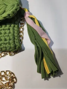 Handmade crochet mobile phone bag with colorful tassel and gold chain strap for women.