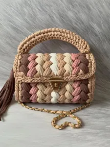 Handmade crochet shoulder bag with colorful braided design, stylish top handle and chain.