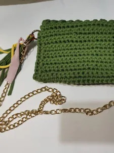 Green crochet mobile phone bag with gold chain strap and colorful tassel for summer daily use.