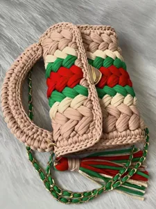 Handmade crochet fabric strip shoulder bag with colorful stripes, metal chain and chic tassel.
