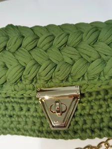 Handmade crochet phone bag in olive green with a sleek gold triangular lock, perfect summer style.