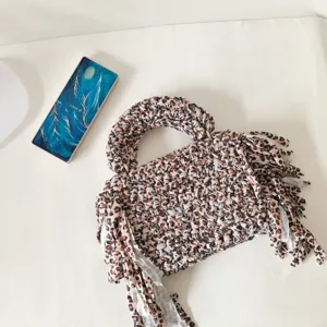 Leopard print fabric crochet handbag with fringe, stylish handmade woven mini tote bag for women.