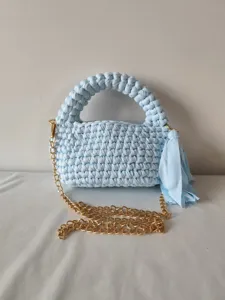Handmade crochet light blue crossbody bag with gold chain and stylish tassel detail.