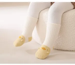 Close-up of cute baby socks with 3D yellow duck design, soft warm fabric for autumn winter.
