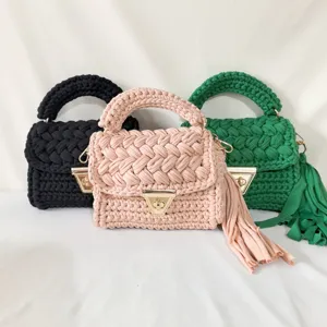 Handmade crochet small square bag, trendy women fabric strip woven handbag detail view.