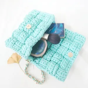 Handmade crochet woven crossbody shoulder bag with chain strap and stylish design.