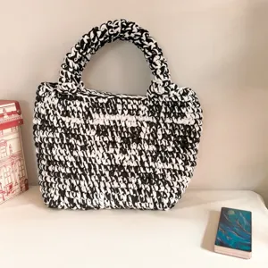 Handcrafted black and white chunky knit tote bag, stylish crochet handbag for women daily use.