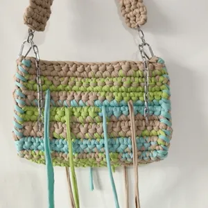 Handmade crochet fabric square bag detail view with colorful stripes and chain strap.