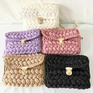Detail shot of handmade chunky knit crochet crossbody bags in five assorted colors